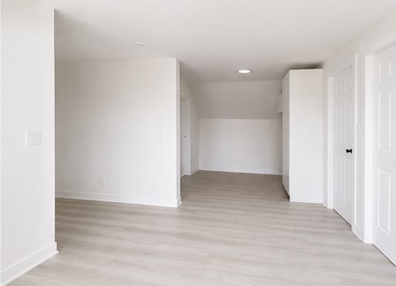 A white room with a door on the right.
