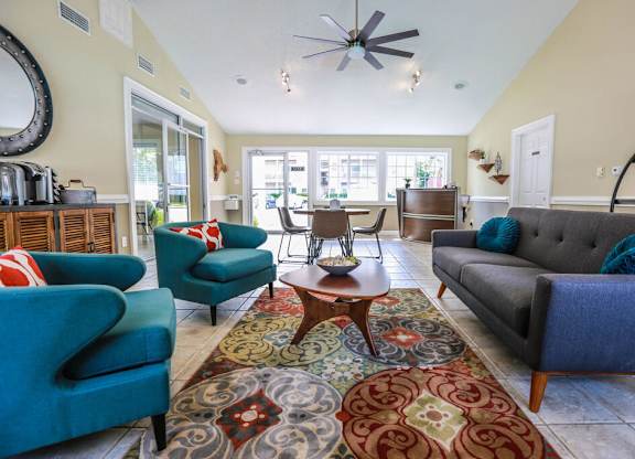 A living room with a grey couch and a blue chair.