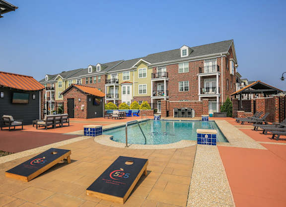 A pool area with a small pool and a slide.