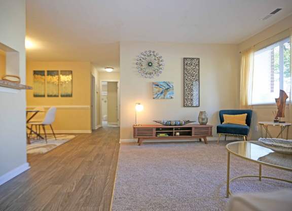 A living room with a white sofa and a grey coffee table.