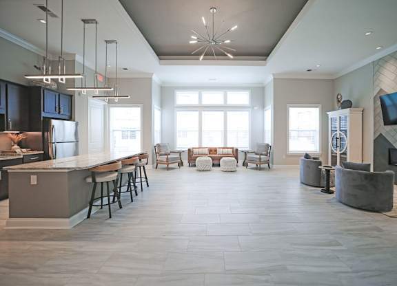 A modern open plan living and kitchen area with a bar.