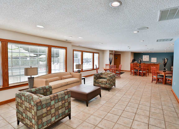 A living room with a couch, chair, and table.