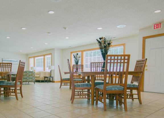 A dining room with a table set for six.