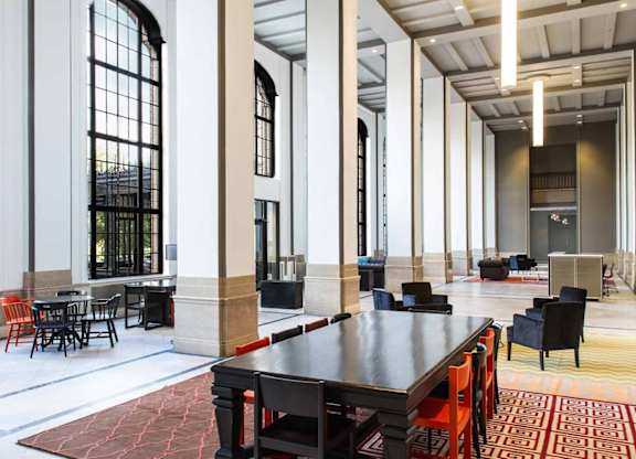 A large room with a long table and chairs.