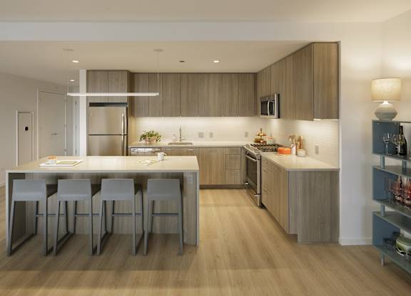 A modern kitchen with a dining table and chairs.