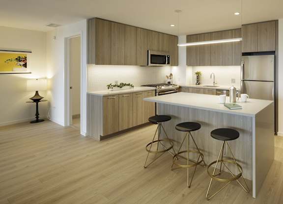 A modern kitchen with a bar stool.