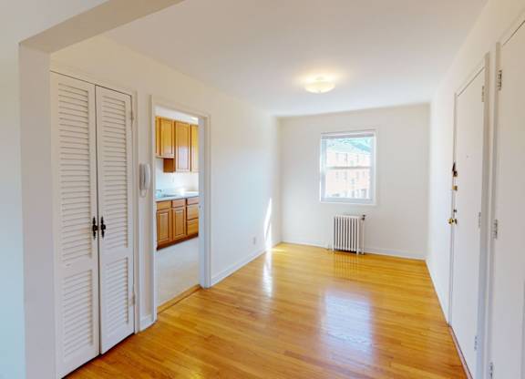 A room with wooden floors and white walls.