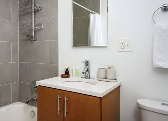 A bathroom with a white sink and a white tub.