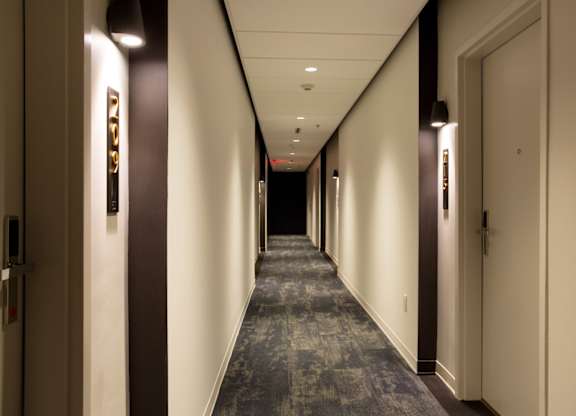 A long hallway with doors on both sides.