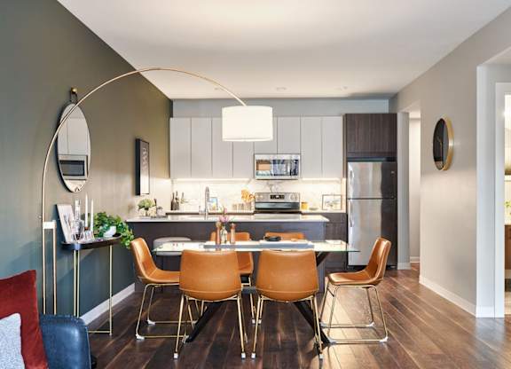 A modern kitchen with a dining table and chairs.