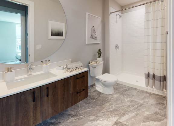 A bathroom with a white toilet and a shower with a curtain.