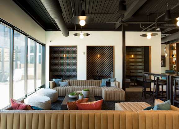 A modern living room with a large sectional sofa and a fireplace.