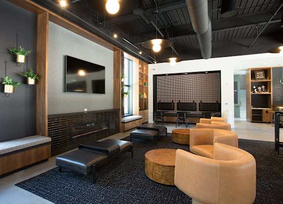 A modern living room with a fireplace and a large screen TV.