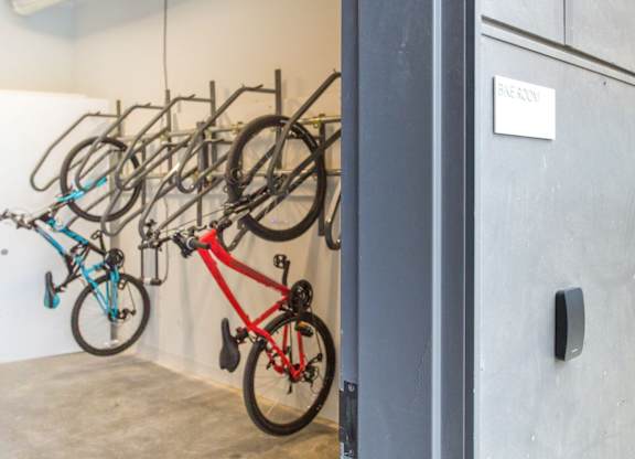 A bike rack with several bikes hanging on it.