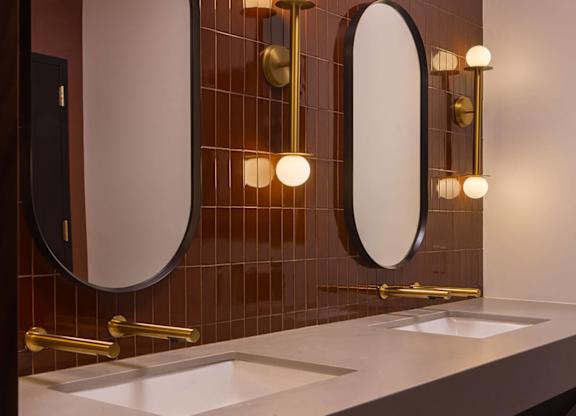 A bathroom with two sinks and two mirrors.