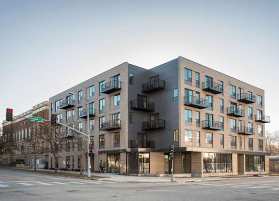 A modern building with a mix of balconies and windows.