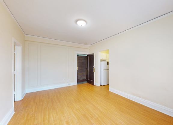A room with wooden floors and white walls.