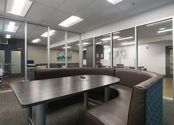 A conference room with a table and chairs.