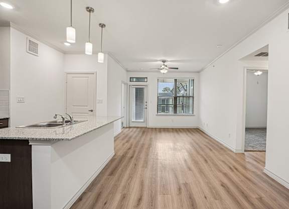 A kitchen with a counter and a sink.