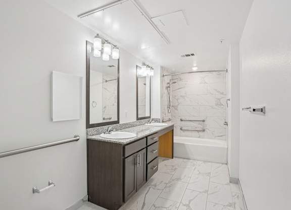 A bathroom with a marble floor and white walls.