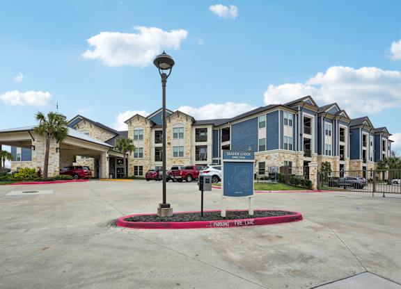A large building with a parking lot in front of it.