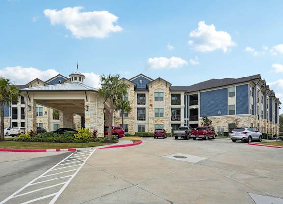 A large building with a parking lot in front of it.