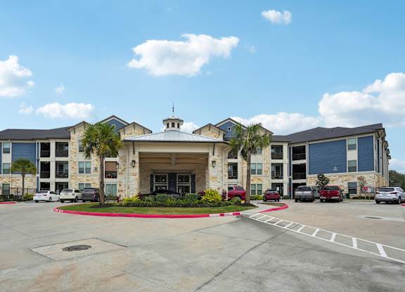 A large building with a parking lot in front of it.