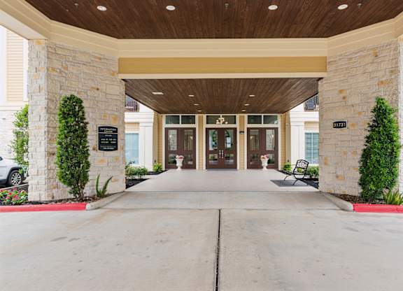 The entrance to a building with a stone pillar on each side.