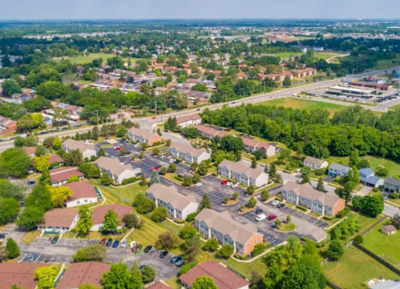 A bird's eye view of a residential area with houses and greenery.