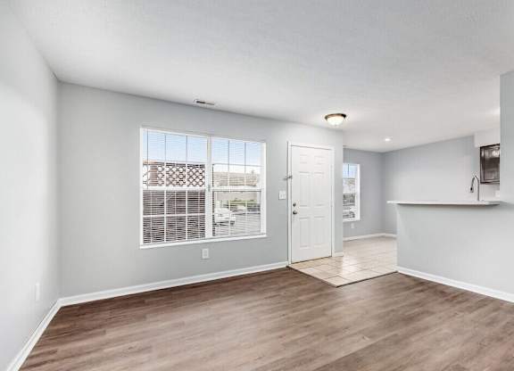 A spacious room with a door leading to another room.