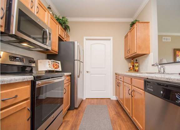 A kitchen with wooden cabinets and stainless steel appliances.