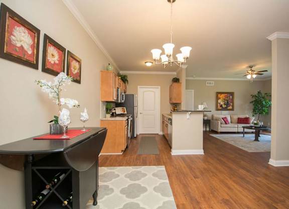 A living room with a dining table and chairs.