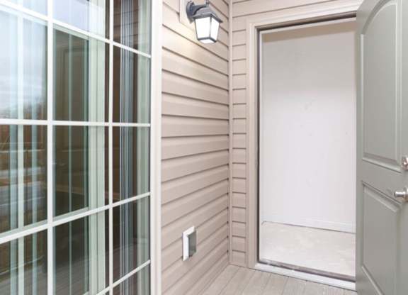 A white door is open to a hallway.