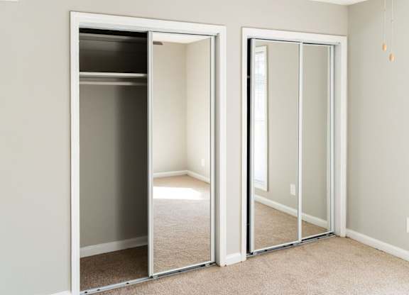 A room with a white door and a white wall.