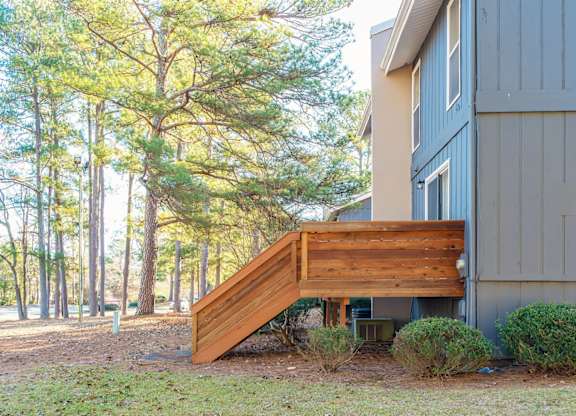 A wooden staircase leads up to a house.