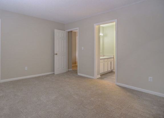 A room with a carpeted floor and white walls.