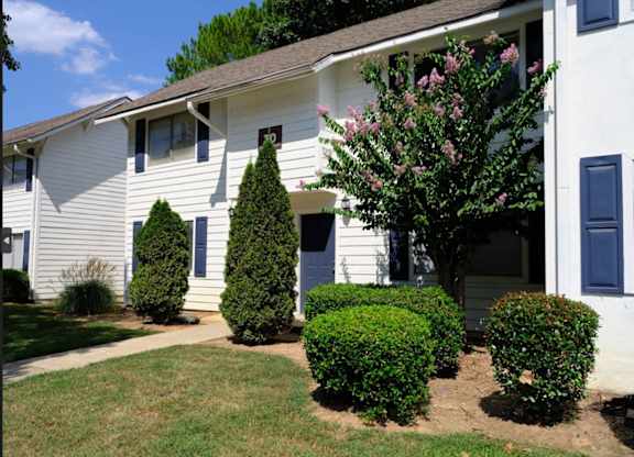 A white house with a blue door and windows.