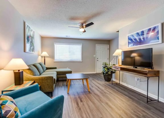 A living room with a blue couch and a television.