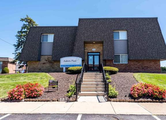 A building with a sign that says "Avalon Place" in front of it.