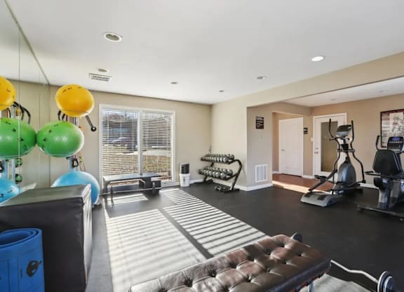 A spacious home gym with a variety of exercise equipment.
