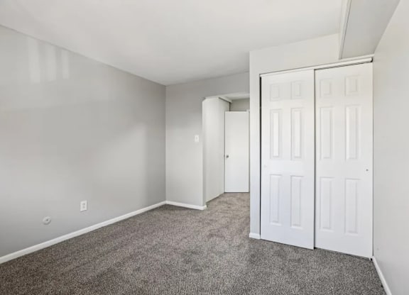 A room with a carpeted floor and white walls.