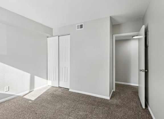 A room with a carpeted floor and white walls.