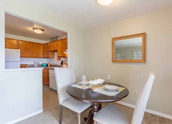A dining room with a table set for two.