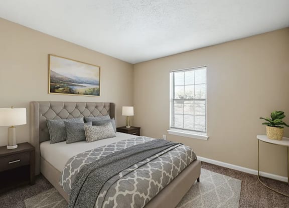 A bedroom with a large bed and a painting on the wall.