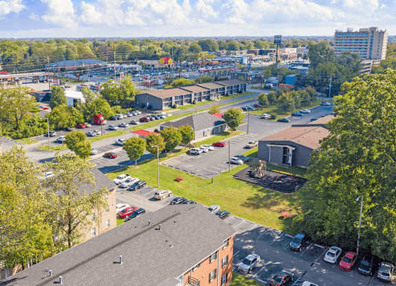 A parking lot with cars and a building in the background.
