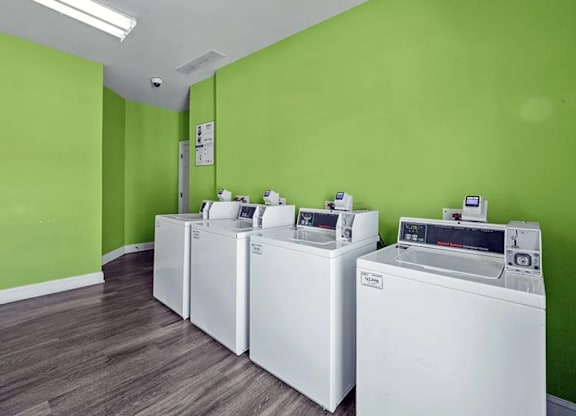A row of washing machines in a laundromat.
