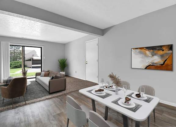 A modern dining room with a white table and chairs.