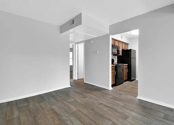 A kitchen area with a refrigerator, oven, and microwave.