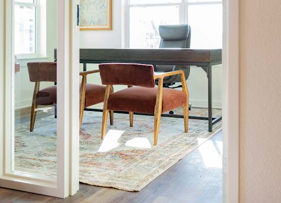 A room with a table and chairs is visible through an open door.