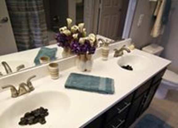 A bathroom with a white counter top and a blue towel.